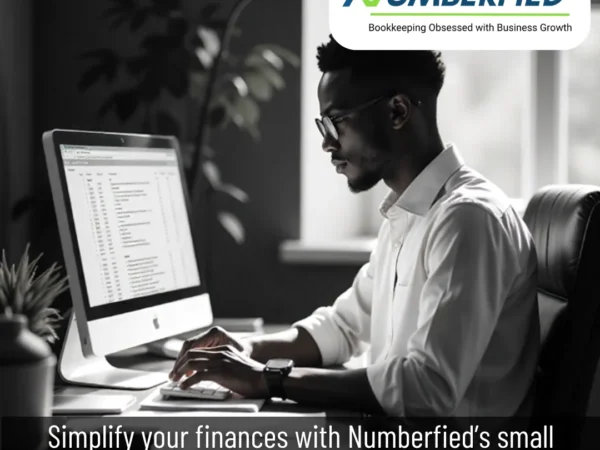 A professional working on a laptop in a modern office, representing Small Business Bookkeeping and Tax Services with accurate financial records and organized tax documents