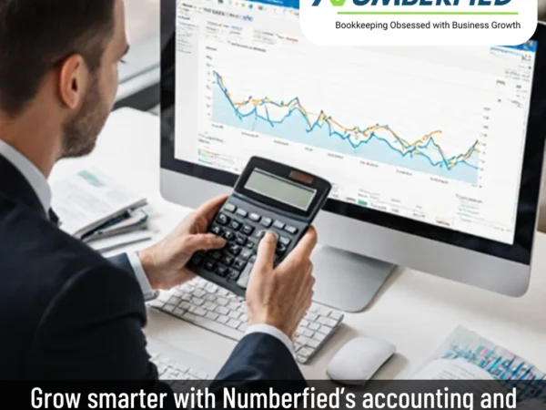 Accountant using calculator and charts to build Accounting and Bookkeeping Services Marketing Plan