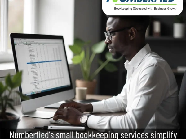 Accountant working on ledgers to manage small bookkeeping services for local business.