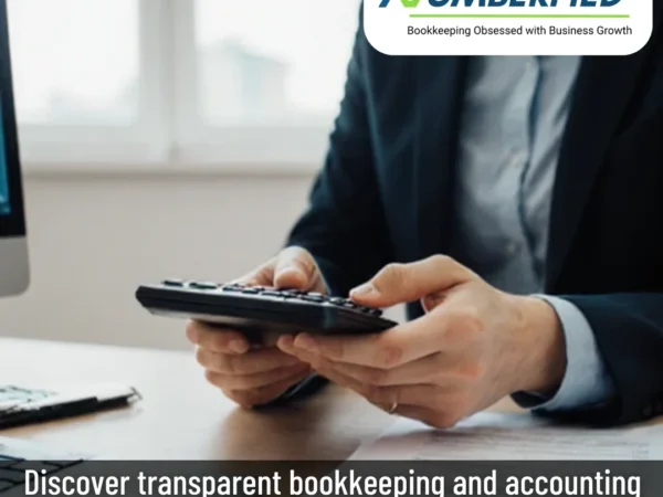 Close-up of hands on calculator working through bookkeeping and accounting services fees.